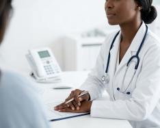 Doctor sitting at desk facing patient